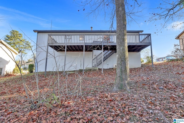 back of property featuring a deck