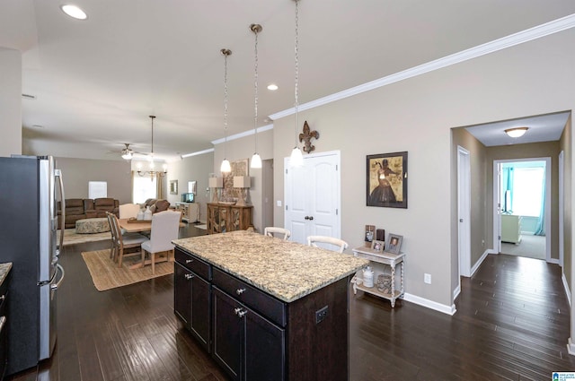 kitchen featuring a center island, stainless steel fridge, crown molding, and dark wood-type flooring