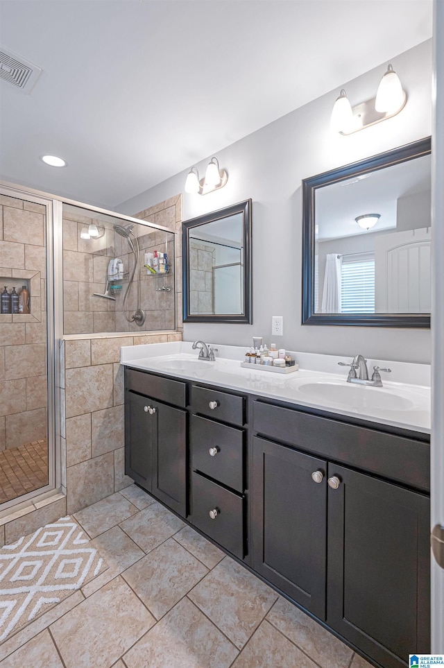 bathroom with vanity and a shower with shower door