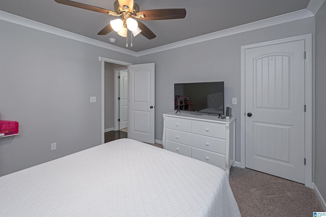 bedroom featuring carpet flooring, ceiling fan, and crown molding