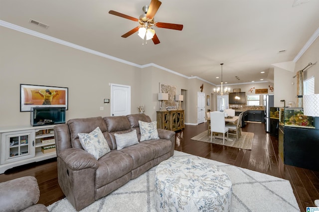 living room featuring dark hardwood / wood-style flooring, ceiling fan with notable chandelier, and ornamental molding