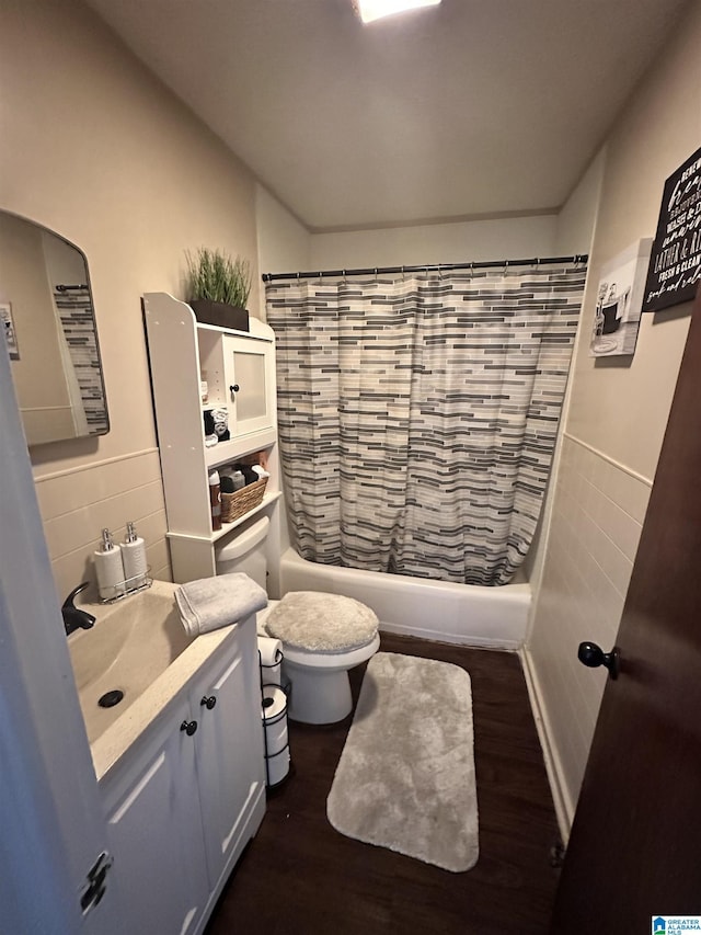 full bathroom with vanity, toilet, shower / bath combo with shower curtain, tile walls, and wood-type flooring