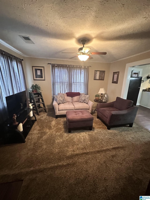 carpeted living room featuring ceiling fan, ornamental molding, and a textured ceiling