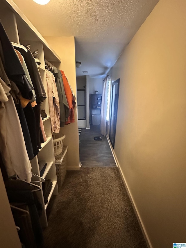 spacious closet featuring dark carpet