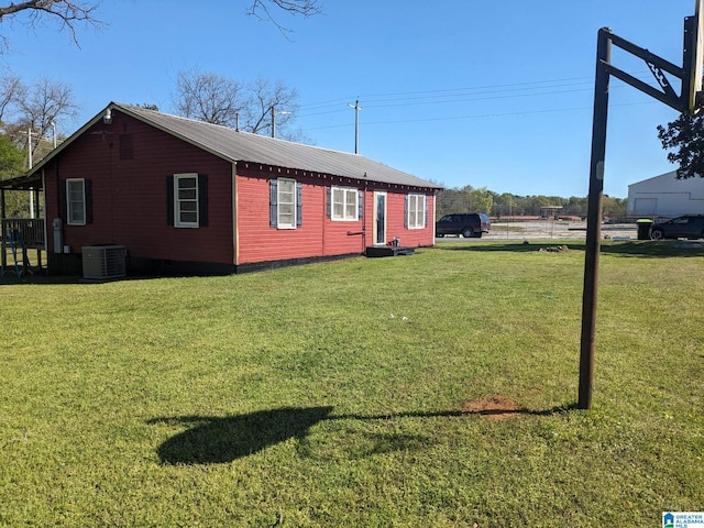 view of home's exterior featuring a lawn and cooling unit