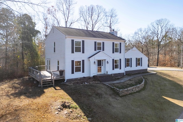 view of front of home with a front yard and a deck