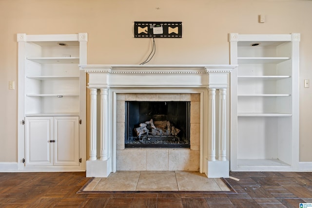 room details with built in features, parquet floors, and a tiled fireplace