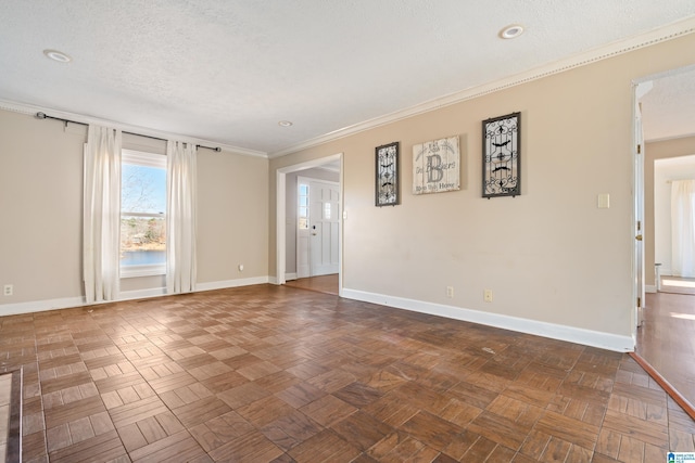 spare room with dark parquet flooring, a textured ceiling, and crown molding