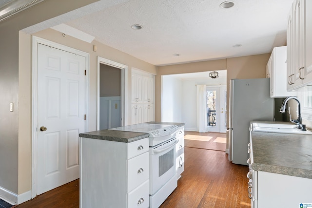 kitchen featuring white cabinetry, a textured ceiling, white electric range oven, a kitchen island, and wood-type flooring