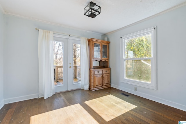 interior space featuring crown molding, french doors, a healthy amount of sunlight, and dark hardwood / wood-style floors