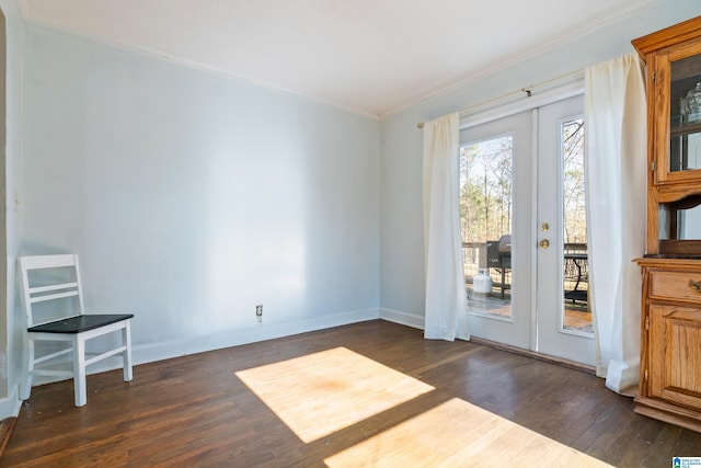 interior space with dark hardwood / wood-style flooring, french doors, and ornamental molding