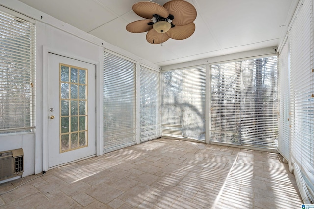 unfurnished sunroom featuring ceiling fan