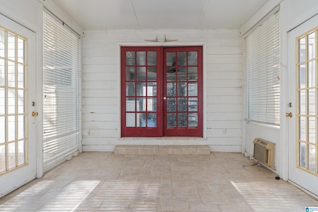 unfurnished sunroom featuring a wall mounted AC