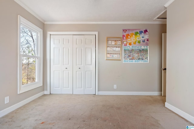 unfurnished bedroom featuring light carpet, a textured ceiling, and crown molding