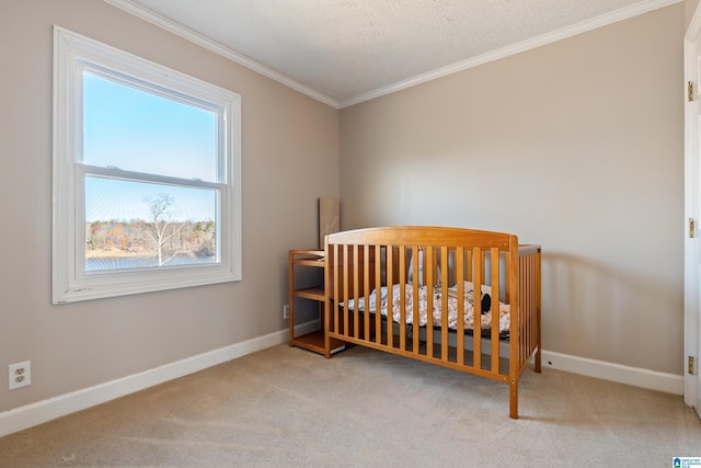 bedroom featuring crown molding, light colored carpet, a textured ceiling, and a nursery area