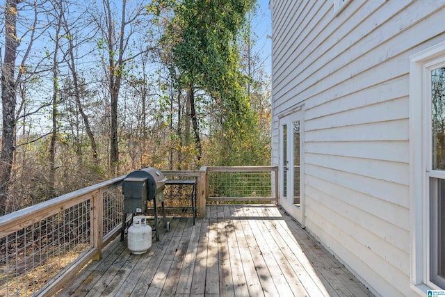 wooden deck with a grill