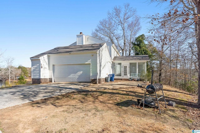 rear view of property featuring a garage