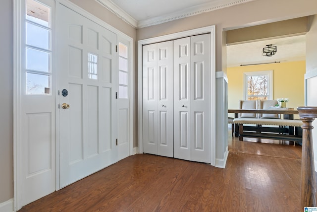 foyer with dark hardwood / wood-style flooring and ornamental molding