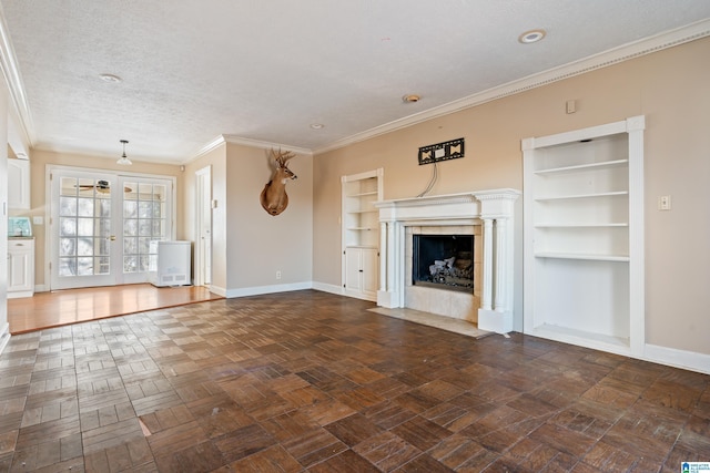 unfurnished living room featuring french doors, dark parquet flooring, ornamental molding, a textured ceiling, and built in features