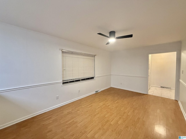 unfurnished room with ceiling fan and light hardwood / wood-style floors