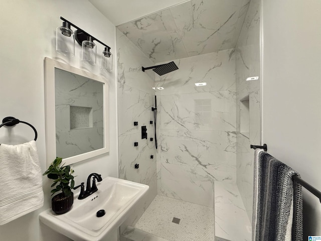 bathroom with sink and tiled shower