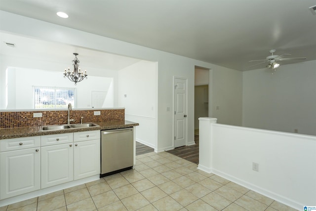 kitchen with dishwasher, white cabinets, sink, hanging light fixtures, and decorative backsplash