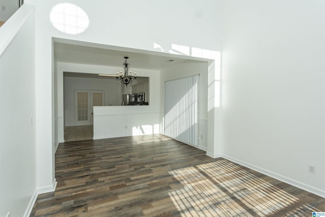 interior space featuring dark wood-type flooring and a notable chandelier