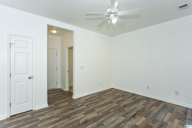 unfurnished room with ceiling fan and dark hardwood / wood-style flooring