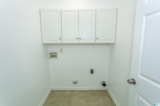 laundry area featuring cabinets, hookup for a washing machine, hookup for an electric dryer, and light tile patterned flooring