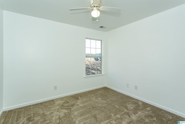 spare room featuring carpet and ceiling fan