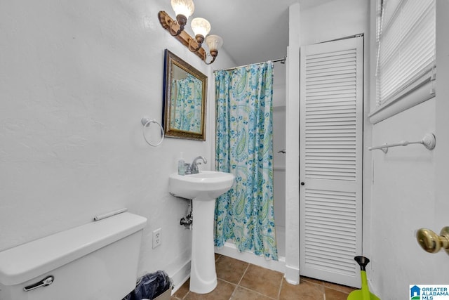 bathroom with tile patterned flooring and toilet