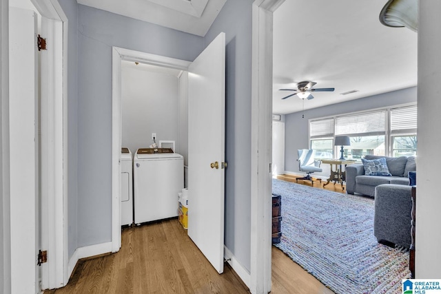 laundry room with washer and clothes dryer, ceiling fan, and hardwood / wood-style floors