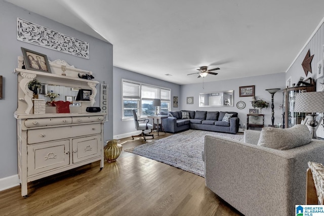 living room featuring hardwood / wood-style flooring and ceiling fan