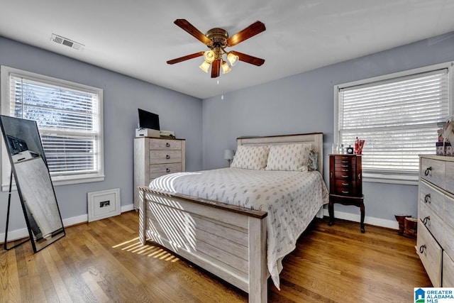 bedroom with ceiling fan and light hardwood / wood-style flooring