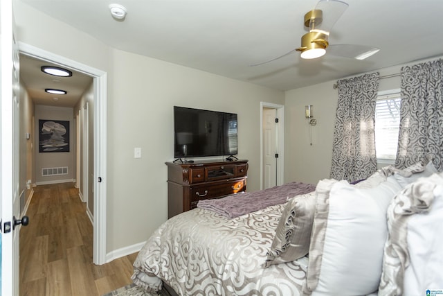 bedroom with ceiling fan and light wood-type flooring