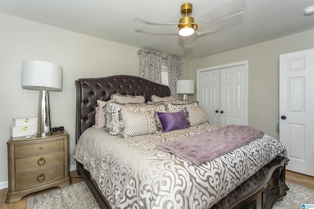 bedroom featuring ceiling fan, a closet, and light wood-type flooring