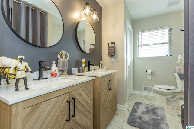 bathroom featuring vanity and toilet