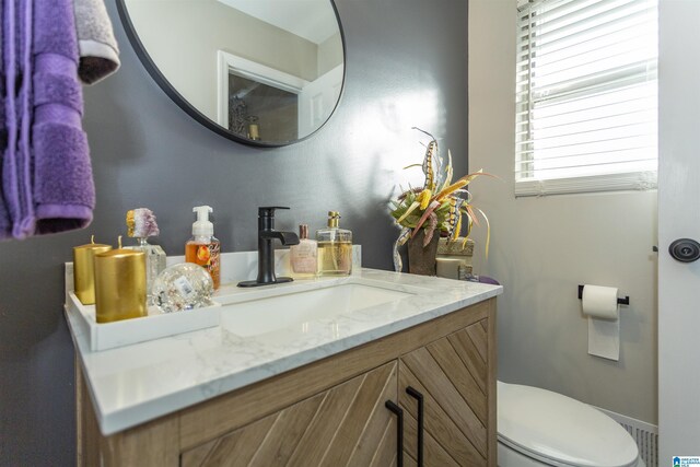 bathroom featuring vanity and toilet