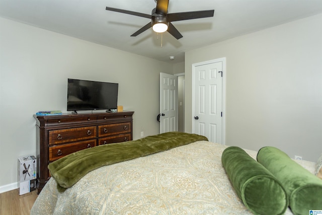 bedroom with ceiling fan and light hardwood / wood-style flooring