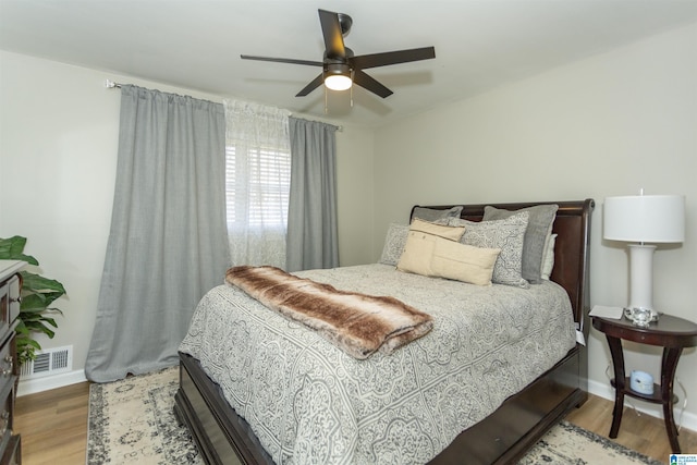 bedroom with ceiling fan and hardwood / wood-style flooring