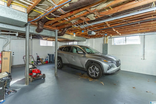 garage with electric panel and a garage door opener