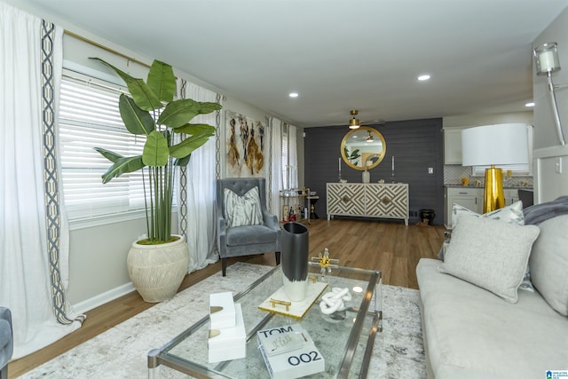 living room featuring a wealth of natural light, dark wood-type flooring, and ceiling fan