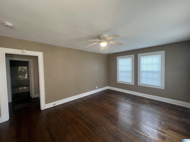 spare room featuring dark hardwood / wood-style floors and ceiling fan