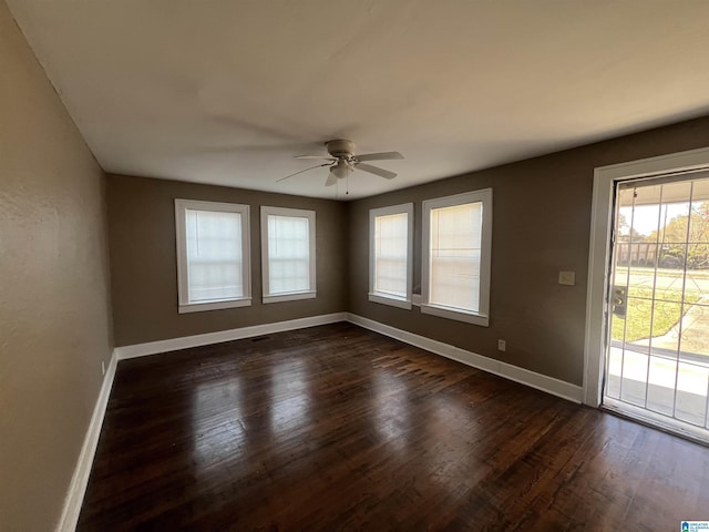 empty room featuring dark hardwood / wood-style flooring and ceiling fan