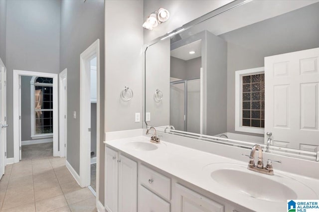 bathroom with tile patterned floors, vanity, and walk in shower