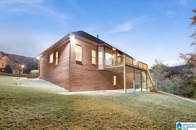 rear view of property with cooling unit, a patio area, a yard, and a deck