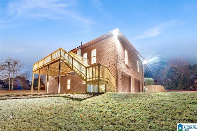 rear view of property with a lawn and a garage