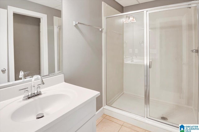 bathroom with tile patterned floors, vanity, and walk in shower