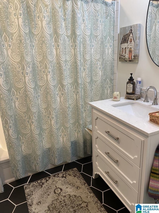 bathroom featuring tile patterned flooring and vanity