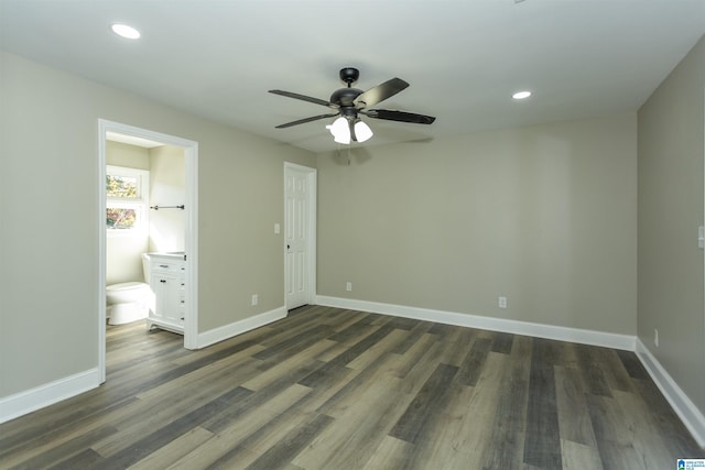 unfurnished bedroom featuring dark hardwood / wood-style floors, ceiling fan, and ensuite bath